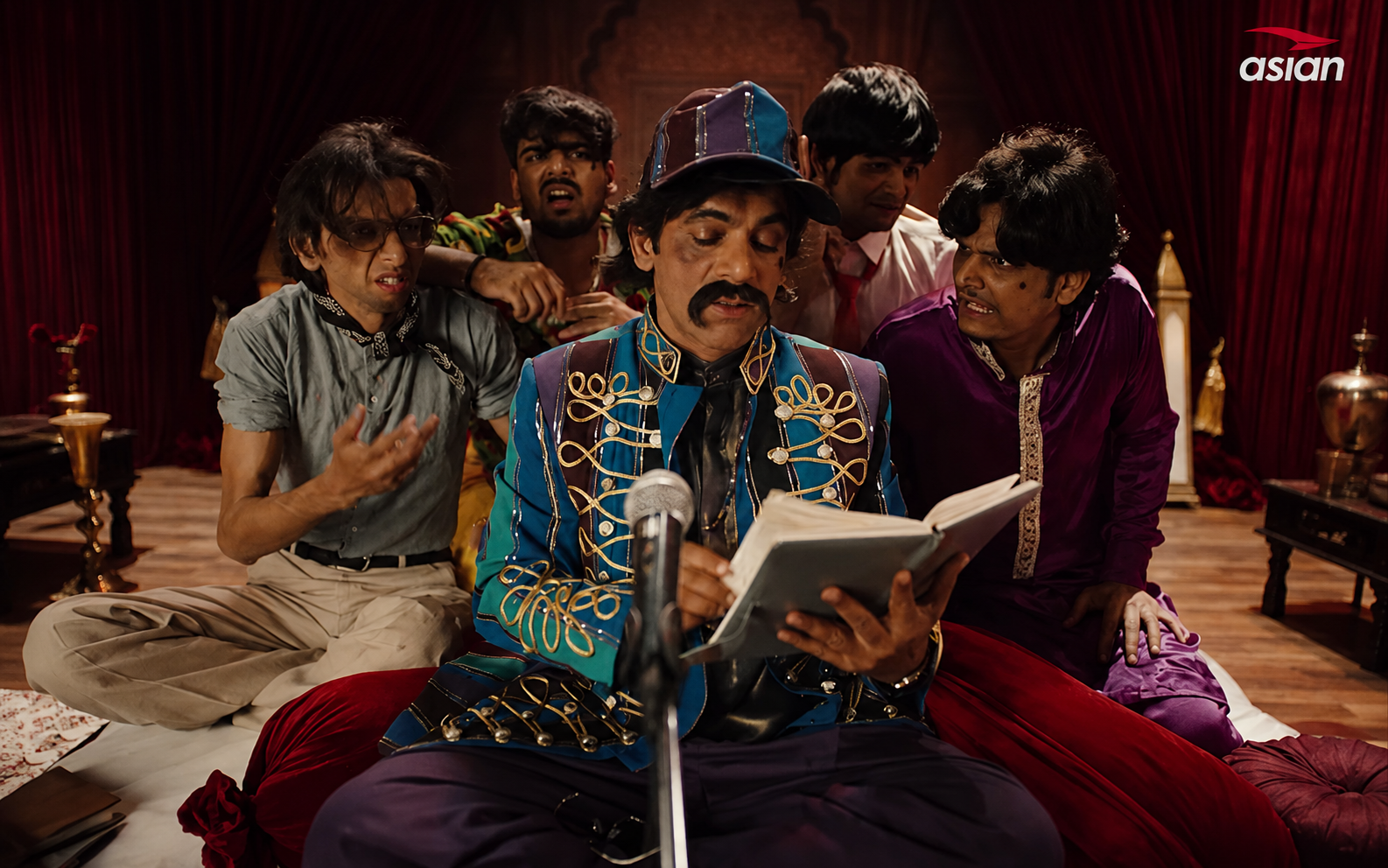 The Brand Strategy Hidden Inside This Hilarious Mushaira Ad featuring Sunil Grover performing poetry on a dramatic stage while a group reacts humorously in a culturally inspired sneaker campaign.