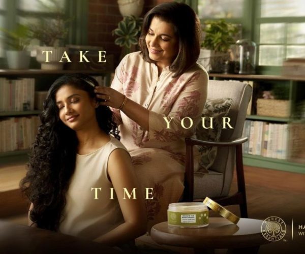 How Forest Essentials Turned Self-Care Into a Premium Experience—mother gently combing daughter’s hair in a warm, serene home setting reflecting mindful self-care