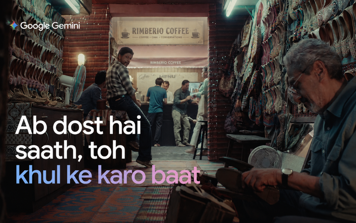 A warm, cinematic scene inside a traditional footwear shop with colorful juttis displayed along the walls, people gathered around a coffee counter, and an artisan working in the foreground. The image features the message, “Ab dost hai saath, toh khul ke karo baat.”