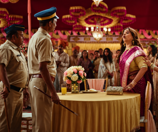 A dramatic wedding scene from Center Fruit’s advertisement shows two police officers confronting guests as a shocked woman reacts in front of a decorated banquet table, showcasing The Storytelling Strategy That Made Center Fruit’s Ad Unforgettable through suspense and humor.