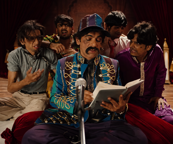 The Brand Strategy Hidden Inside This Hilarious Mushaira Ad featuring Sunil Grover performing poetry on a dramatic stage while a group reacts humorously in a culturally inspired sneaker campaign.