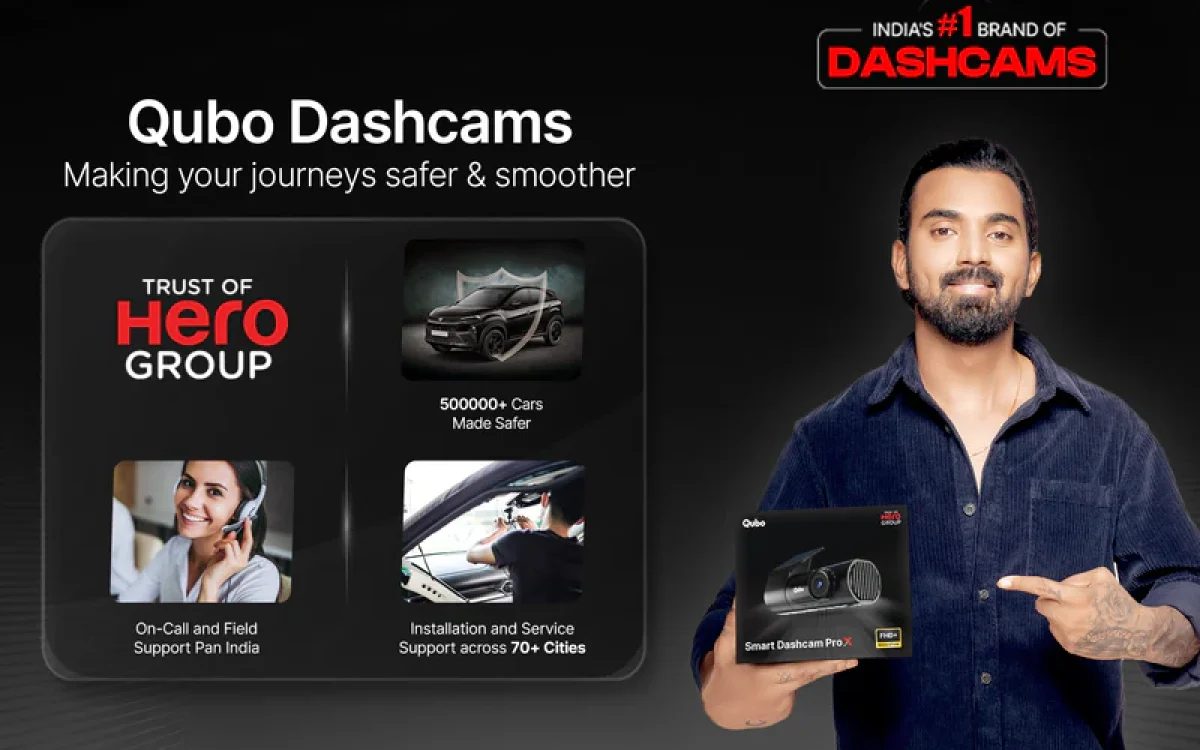 Qubo Dashcams ad featuring a male brand ambassador holding a dashcam box, highlighting safety features, Hero Group trust, and protection against fake accident claims