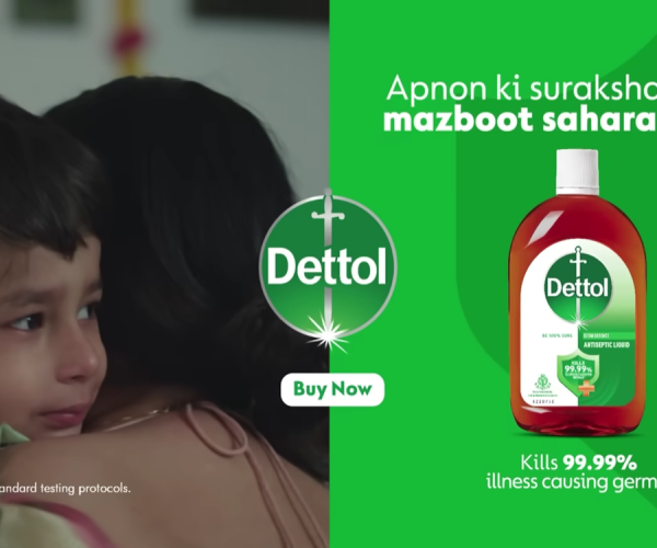 A touching scene from Dettol’s Mother’s Day advertisement showing a child emotionally hugging their mother beside a Dettol antiseptic liquid product display, highlighting family care, protection, and emotional storytelling.