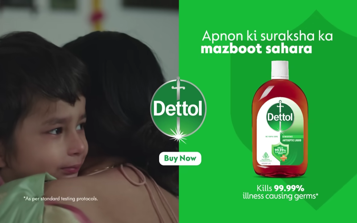 A touching scene from Dettol’s Mother’s Day advertisement showing a child emotionally hugging their mother beside a Dettol antiseptic liquid product display, highlighting family care, protection, and emotional storytelling.